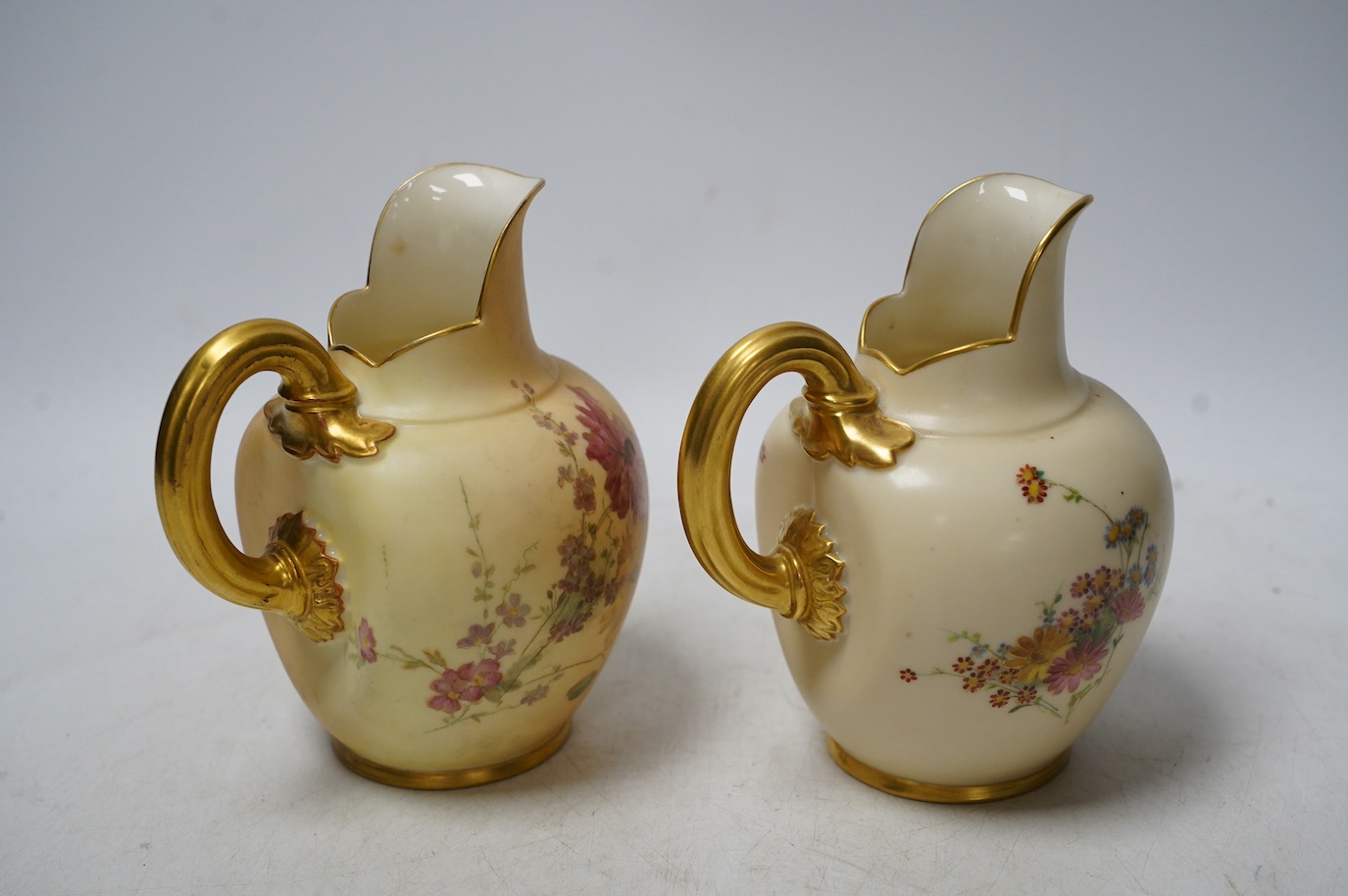 Two Worcester 1094 shape blush ivory floral jugs, 14cm high. Condition - good